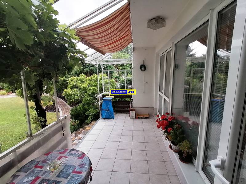 Terrace of a family house on J.Š.Šikuru Street in Martin with flowers and a table.