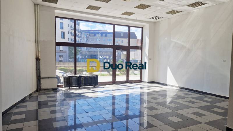 Bright commercial spaces with large windows and tiled floors.