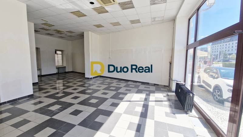 Commercial spaces with large windows, tiles, and white walls.