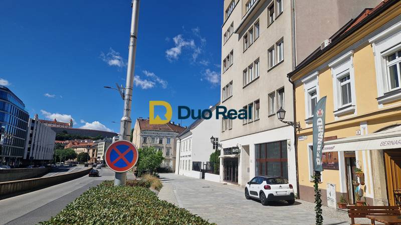 Konventná Street in Bratislava - Old Town, commercial spaces and traffic sign.