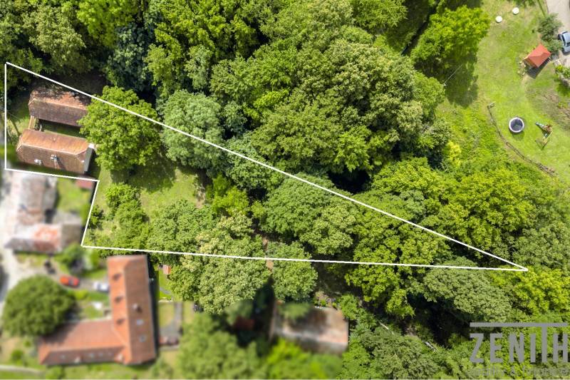 Aerial view of the land and buildings, surrounded by forest in Brezová pod Bradlom, Dzurákovci street.