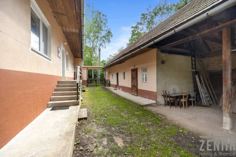 A family house on Dzurákovci Street in Brezová pod Bradlom with a yard and outdoor seating area.