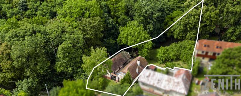 Aerial view of a family house in Brezová pod Bradlom on Dzurákovci Street, surrounded by forest.