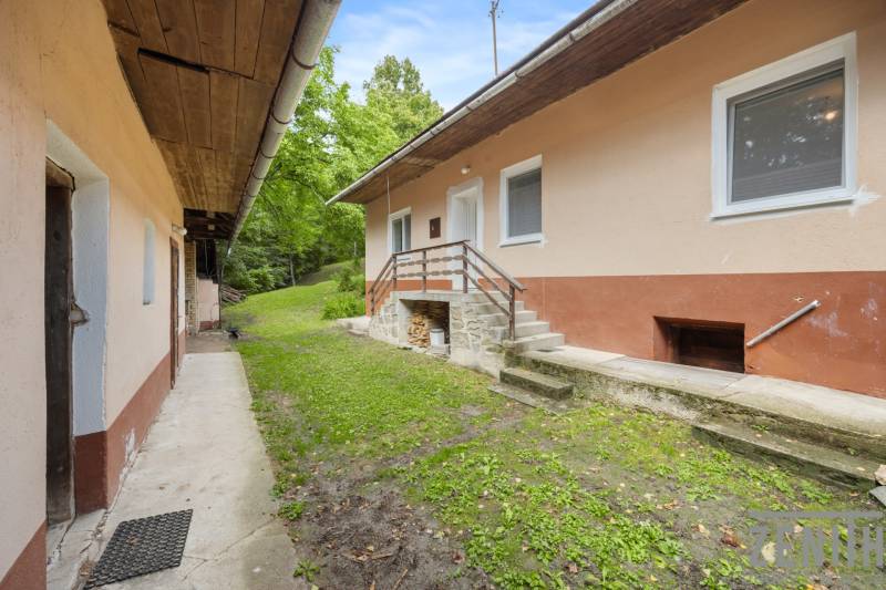 A family house on Dzurákovci Street in Brezová pod Bradlom with a green forecourt and stairs.
