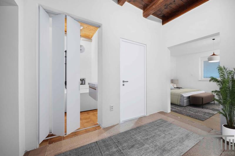 A family house with white folding doors, a bedroom, and a plant inside the room.