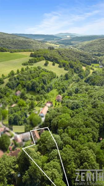Aerial view of forests and landscape near a family house in Brezová pod Bradlom on Dzurákovci Street.