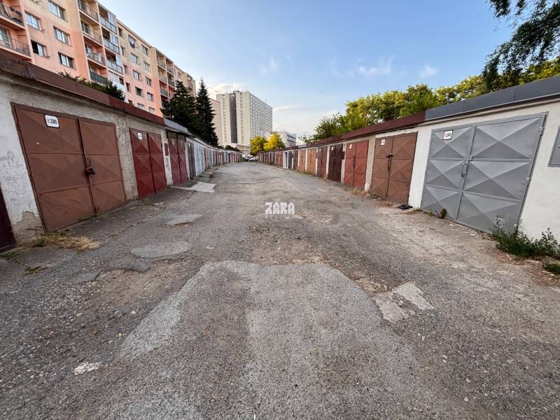 Garages on Považská Street in Košice, the Západ district, are lined by panel buildings.