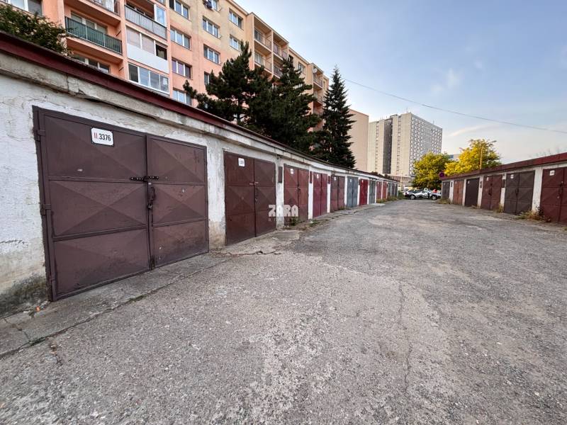 Garages on Považská Street, Košice - Západ district, surrounded by apartment buildings.