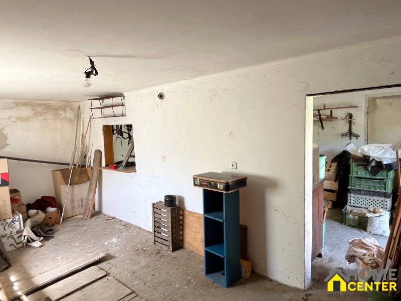 A room in a family house with stored items and clutter.