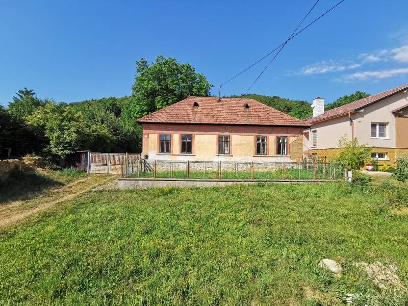 A family house on a street in Nitrianske Sučany, surrounded by a green plot and nature.