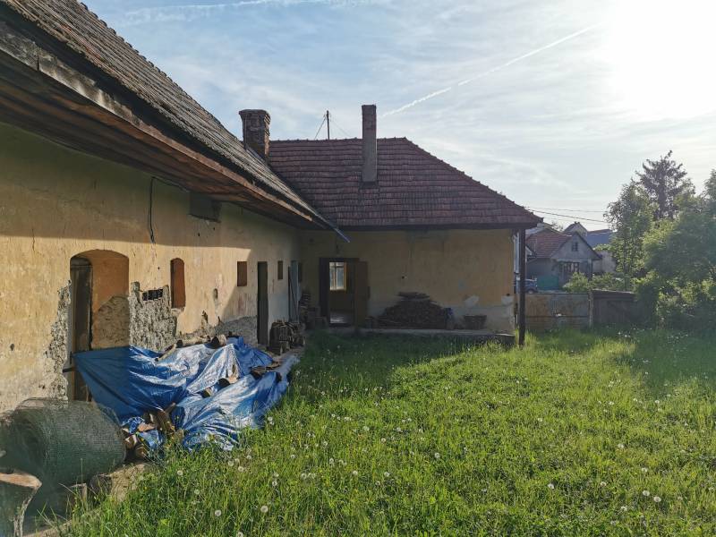 An older family house in Nitrianske Sučany on Nitrianske Sučany Street with a grassy plot.