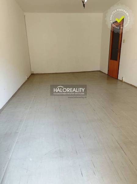Empty room with a floor and light walls in a studio apartment.
