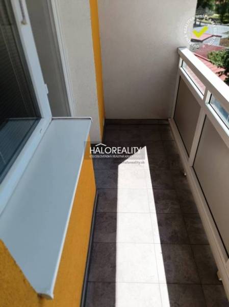 A balcony of a one-room apartment with glazing and a view of the surroundings of Krompachy.
