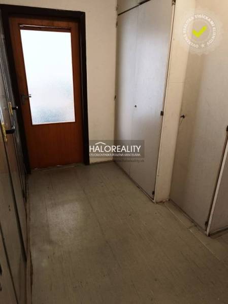 Hallway with storage space in a studio apartment with wooden doors.