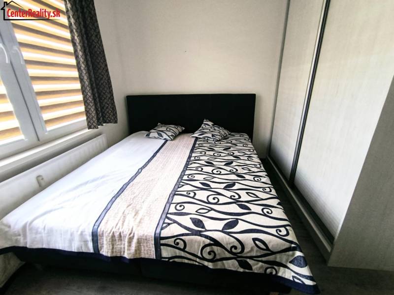 Bedroom in a 3-room apartment with a double bed and a wardrobe.