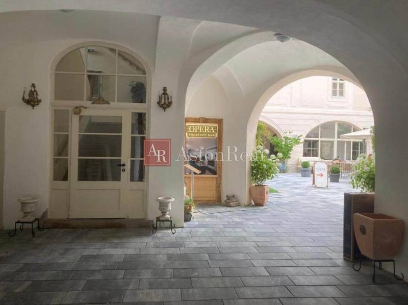 Historic courtyard with arcades, commercial space, and café bar in Banská Štiavnica.