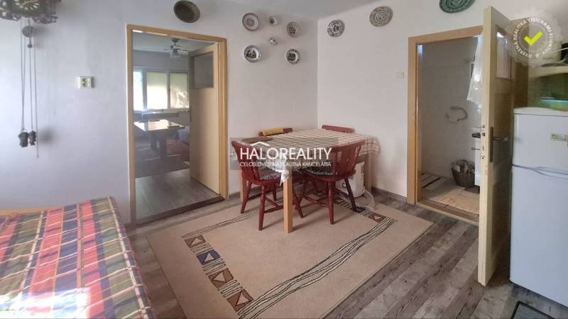 Interior of a family house with a dining room, decorative walls, and basic furnishings.