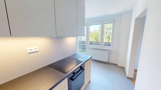 Kitchen in a 2-room apartment with a view, bright walls and windows.