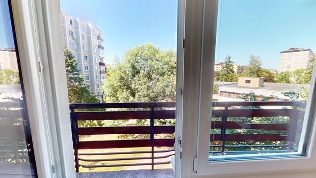 View from a 2-room apartment on Centrum I Street in Dubnica nad Váhom, with a balcony and greenery.
