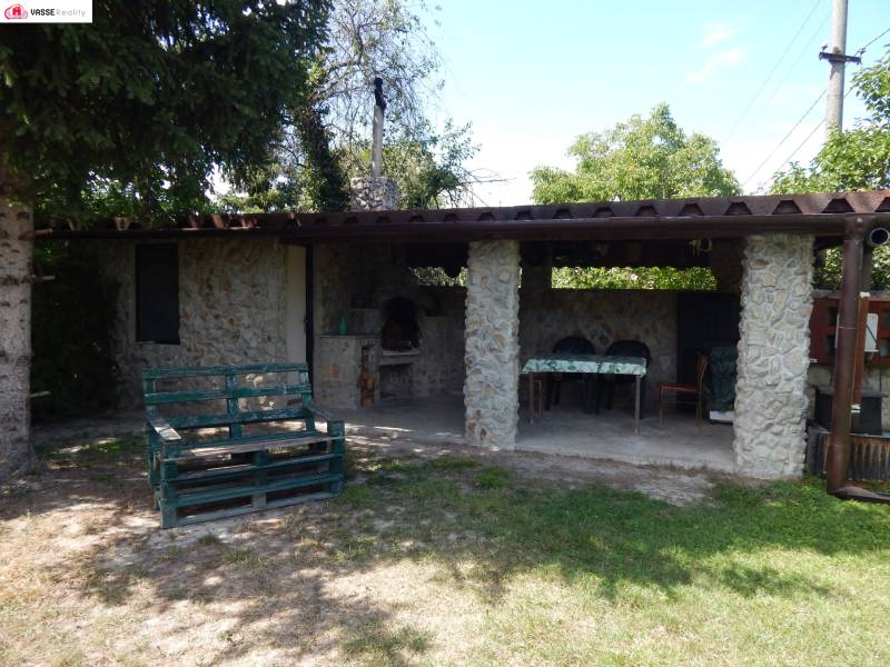 A cottage in Klížska Nemá with outdoor seating, a grill, and garden furniture.