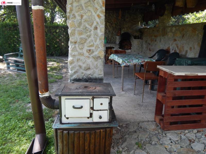 A magical cottage in Klížska Nemá with a stove and a garden seating area for relaxation.