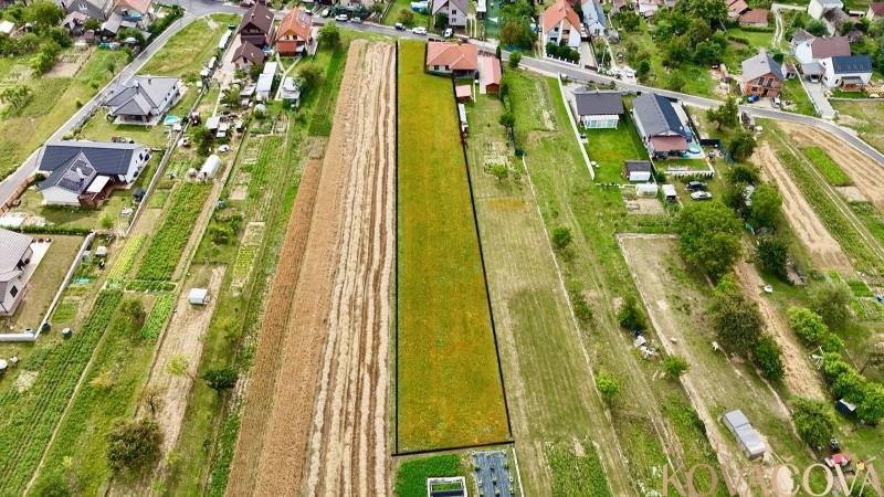 An aerial view shows residential plots in Trenčianske Jastrabie surrounded by houses and gardens.