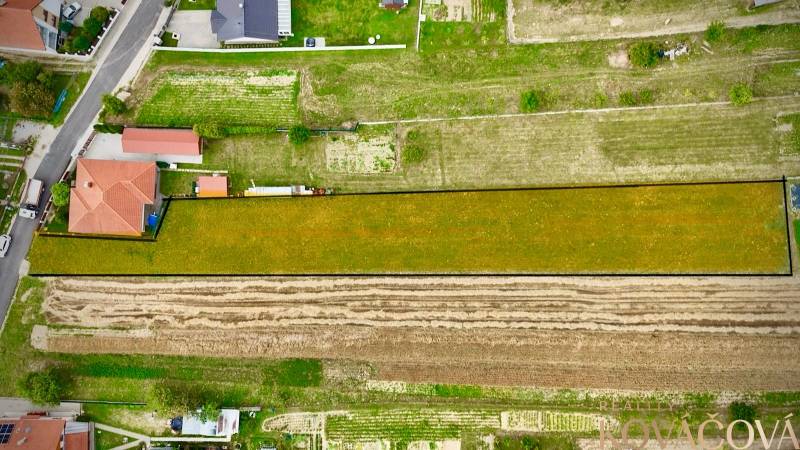 Aerial view of extensive properties - housing in Trenčianske Jastrabie surrounded by greenery and houses.