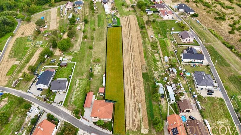 Aerial view of properties in Trenčianske Jastrabie with family houses and road infrastructure.