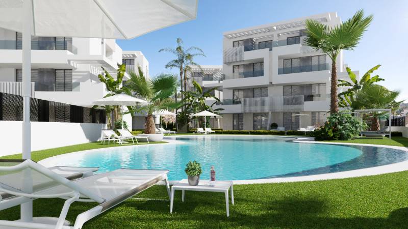 A swimming pool surrounded by loungers and palm trees at a 3-bedroom apartment on Santa Rosalia Lake street.