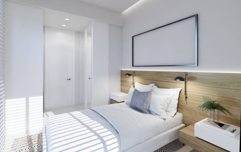 Bedroom in a 3-room apartment with a bed, nightstands, and a built-in wardrobe.