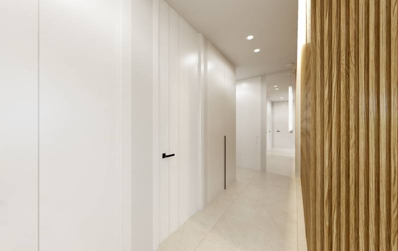 A minimalist hallway in a 3-room apartment with white walls and wooden paneling.