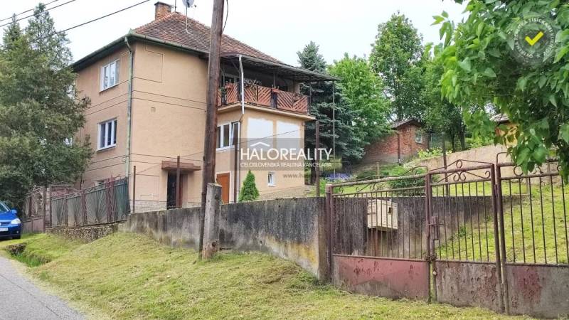 A family house in České Brezovy with a large garden, fencing, and a veranda.