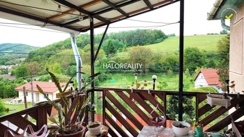 The terrace of a family house in Český Brezov with a view of green hills and gardens.