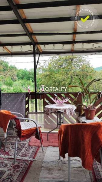 The balcony of a family house in České Brezové, seating and a view of greenery.