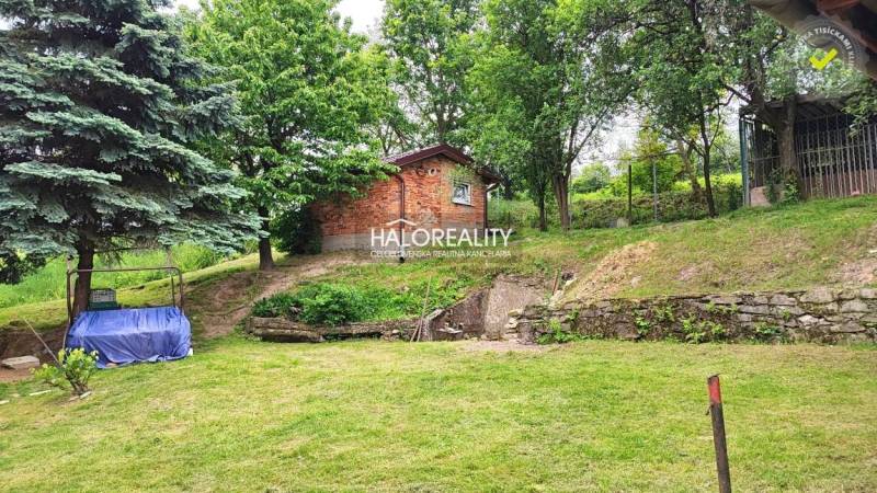A garden at a family house in České Brezové with a gazebo and trees on a grassy area.