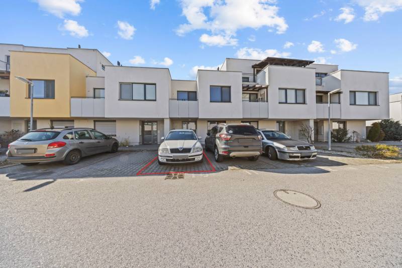 On Mesačná Street, there is a parking lot in front of the row houses and an outdoor 2-room apartment.