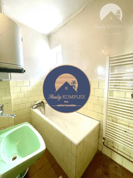 Bathroom in a family house with a bathtub and a sink in a family house.