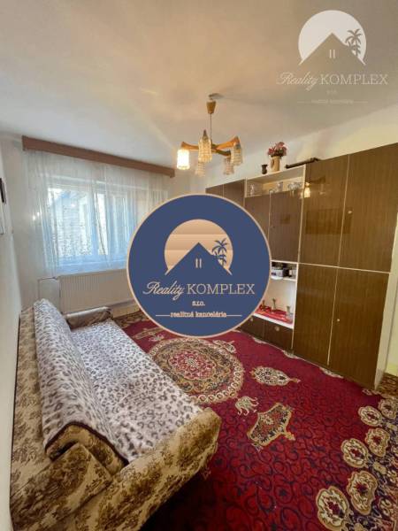 Living room in a family house with carpets and a sofa set.