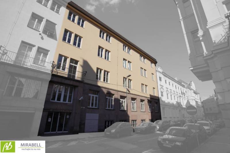 The building on Gunduličova Street in Bratislava - Old Town surrounded by cars in a row of buildings.