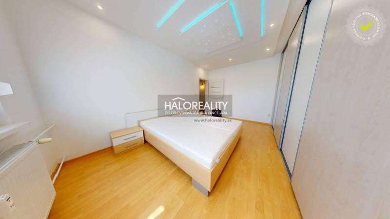 Bedroom in a 4-room apartment with wooden flooring and a bed.
