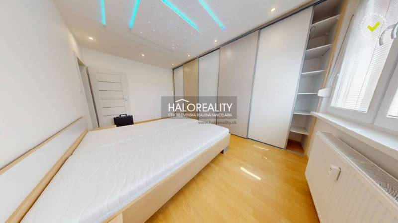 Bedroom in a 4-room apartment with built-in wardrobes and ceiling lighting.