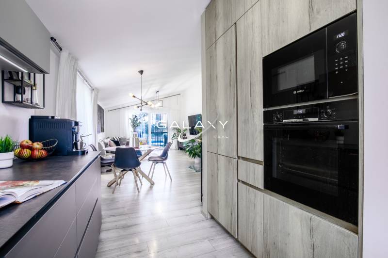 A kitchen in a family house with stylish equipment and a dining table.