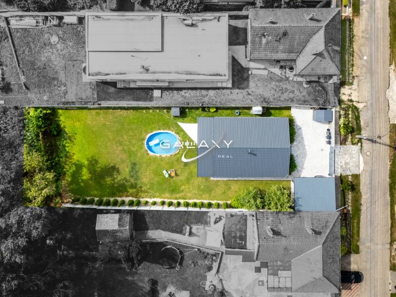 Aerial view of a family house in Čierna Voda, with a swimming pool and garden.