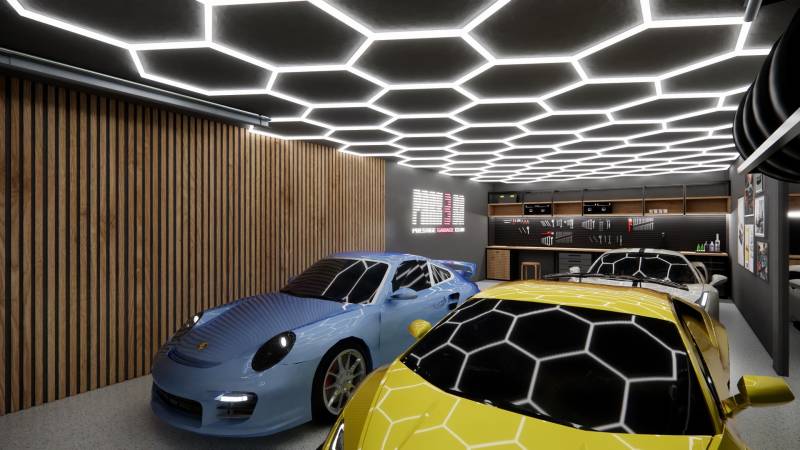 Commercial spaces with parked sports cars and modern ceiling lighting.