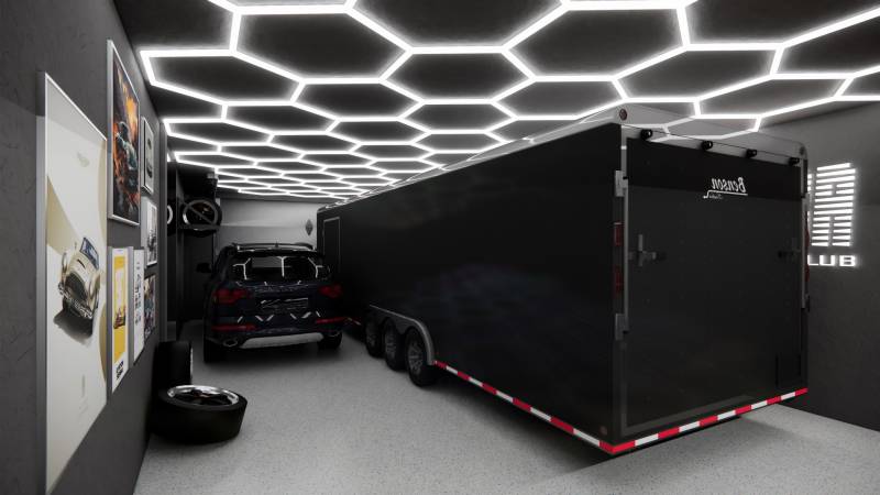 Commercial space with a car, trailer, light ceiling, and art posters on the wall.