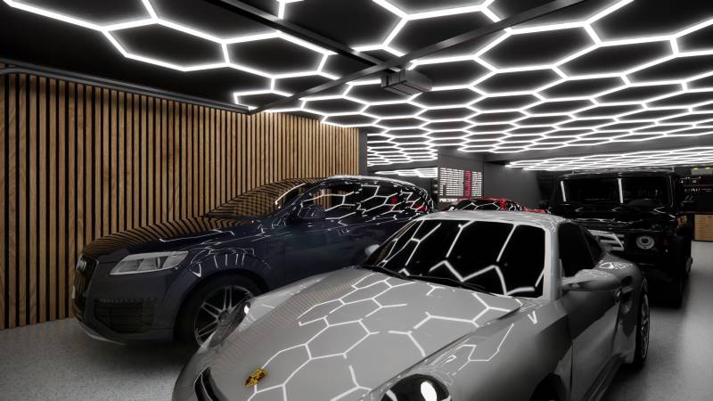 Auto underlit with hexagonal ceiling lights, wooden wall, garages.
