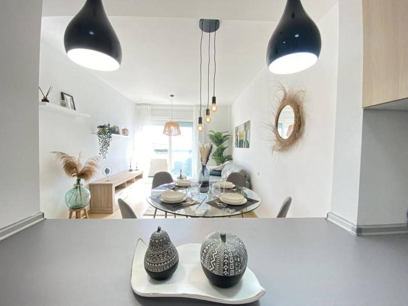 Dining area with decorations and a large window in a 3-room apartment.