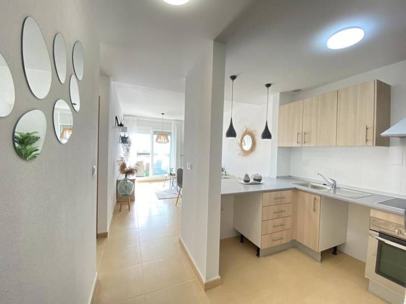 A kitchen with a dining area and mirrors in a 3-room apartment, bright and cozy atmosphere.