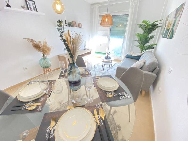 Dining room and living room in a 3-room apartment with subtle decor and furniture.