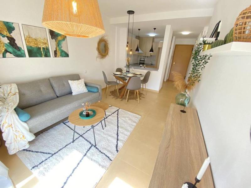 A bright living space in a 3-room apartment with a carpet and a dining area.